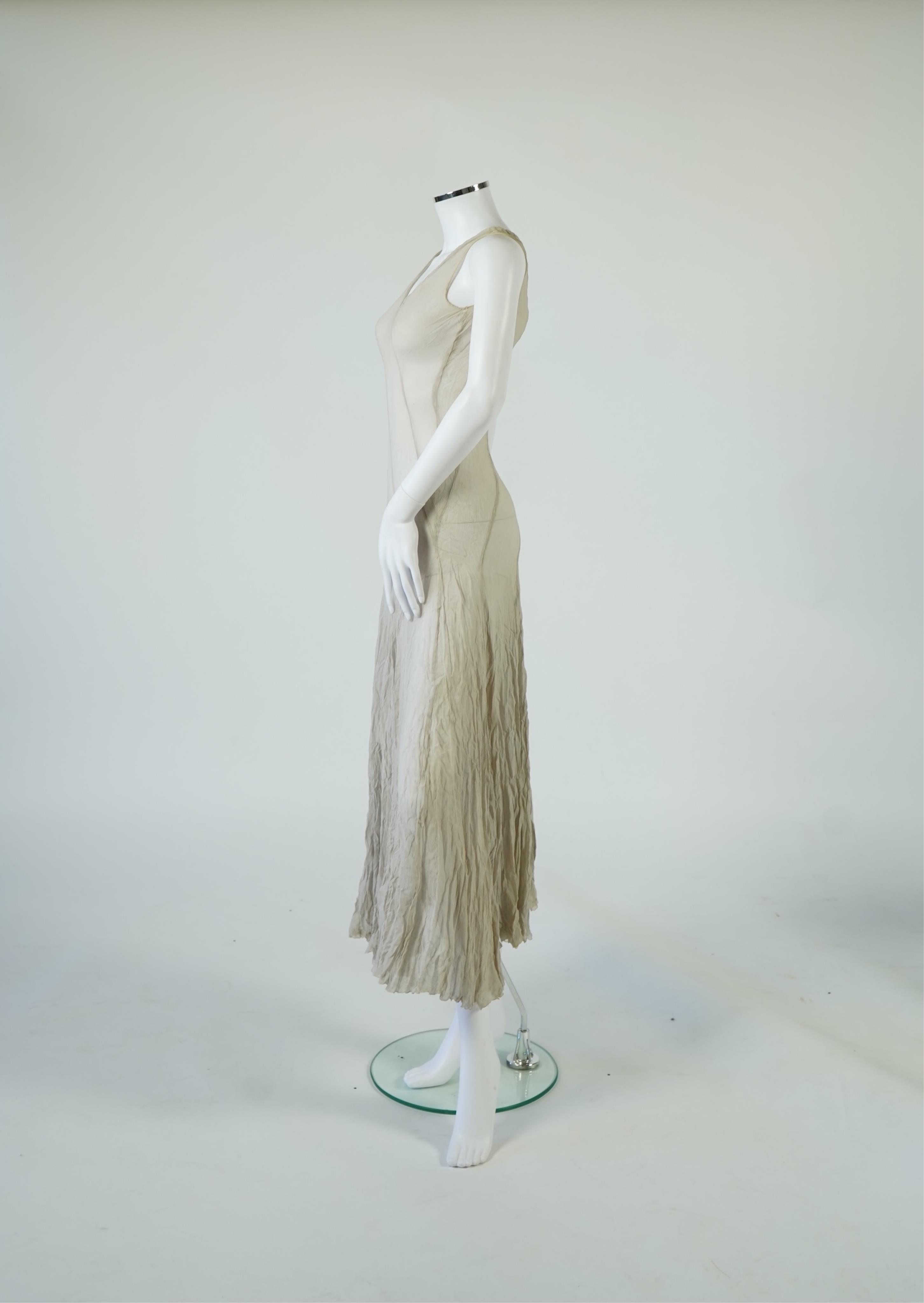 A 1930's grey chiffon bias cut ladies evening dress. 120cm long. Condition - has a small hole at the back and a light mark possibly removed with washing.